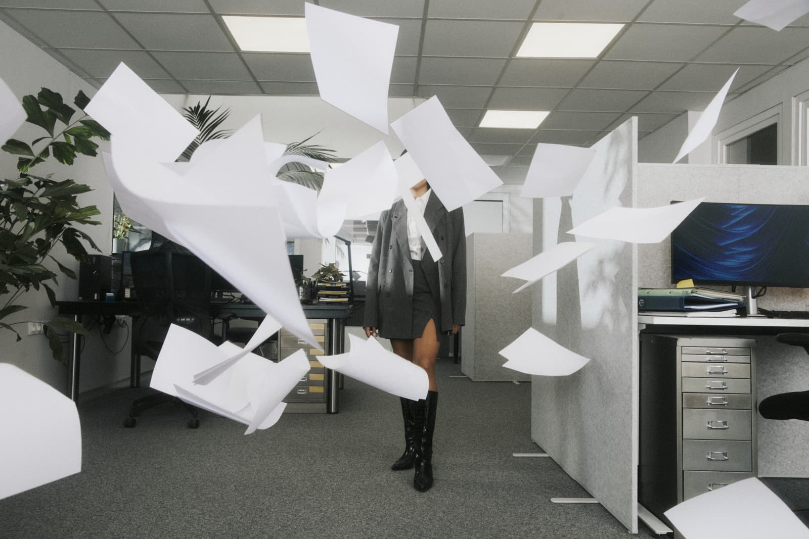 Loose pages flying through an open-plan office